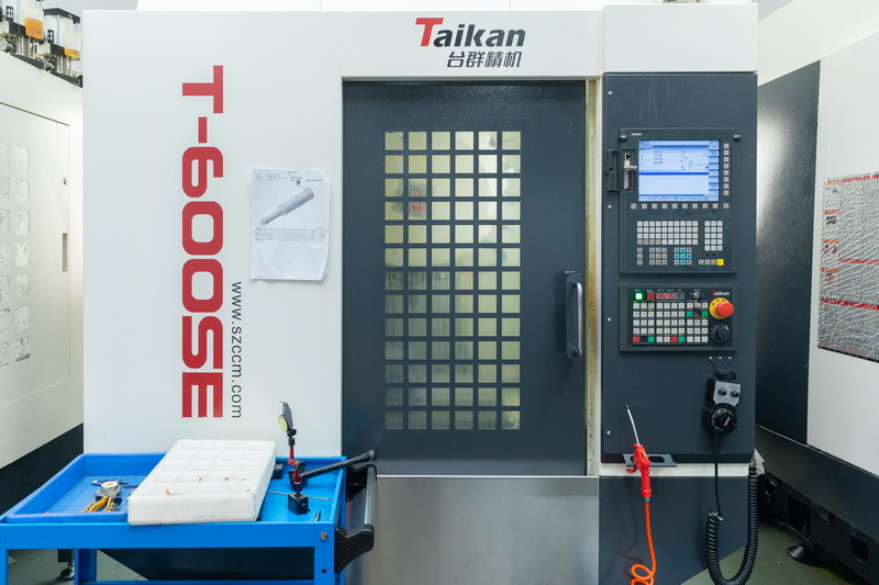 Taikan T-600SE enclosed vertical machining centre with dark door and CNC control panel