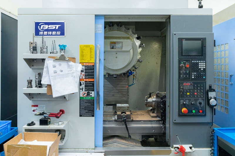 BST enclosed CNC machining centre with door open showing tool magazine and spindle assembly