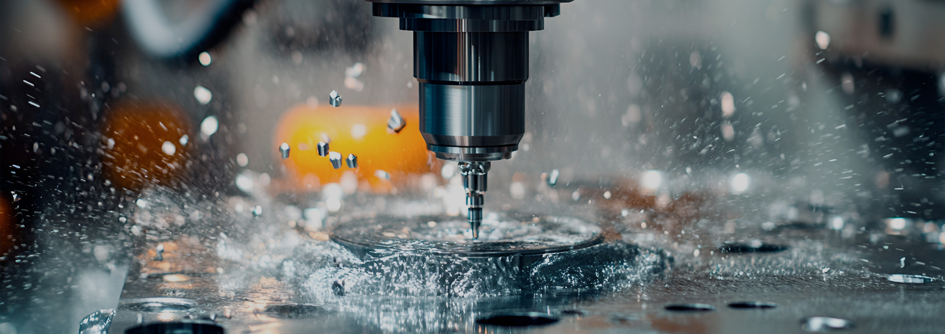 5-axis CNC machining centre cutting a metal part under coolant